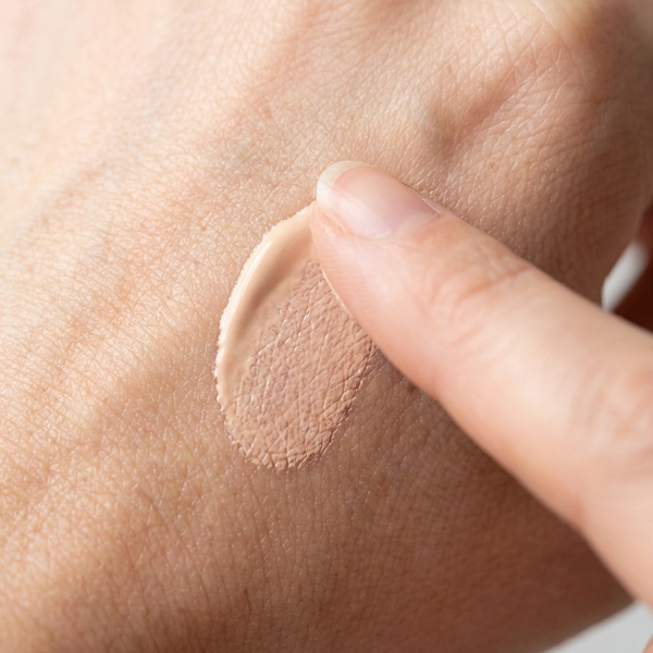 Sheer skin-adaptive tint blending into different skin tones